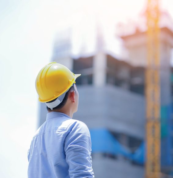 engineer looking a building site and safety helmed.